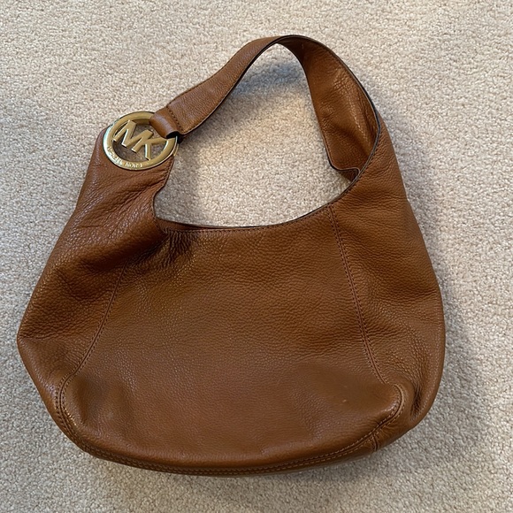 Michael Kors tan leather purse. Gold emblem. Gently used
Snap closure dust bag - Picture 3 of 9